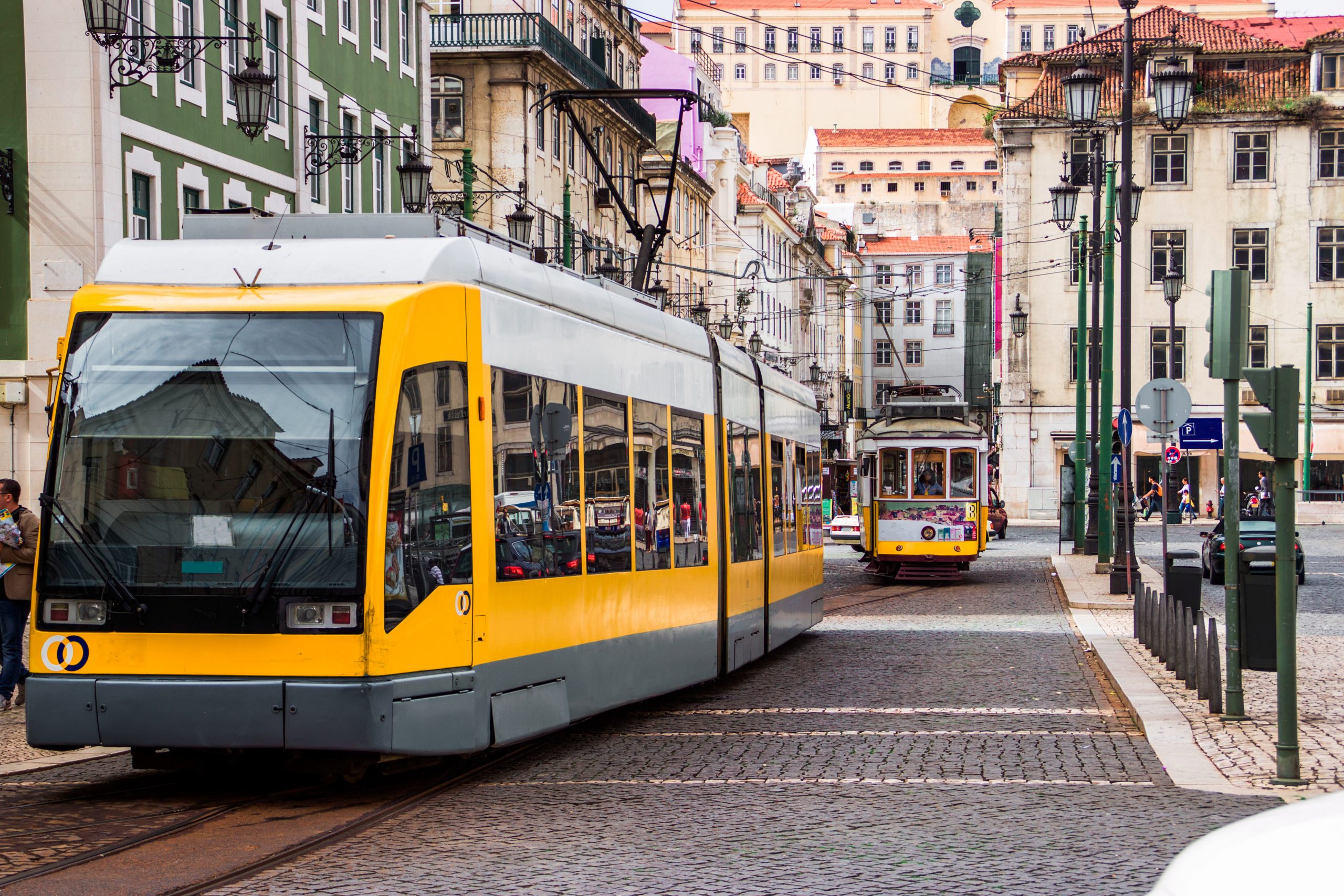 yellow lisbon tram on the old street