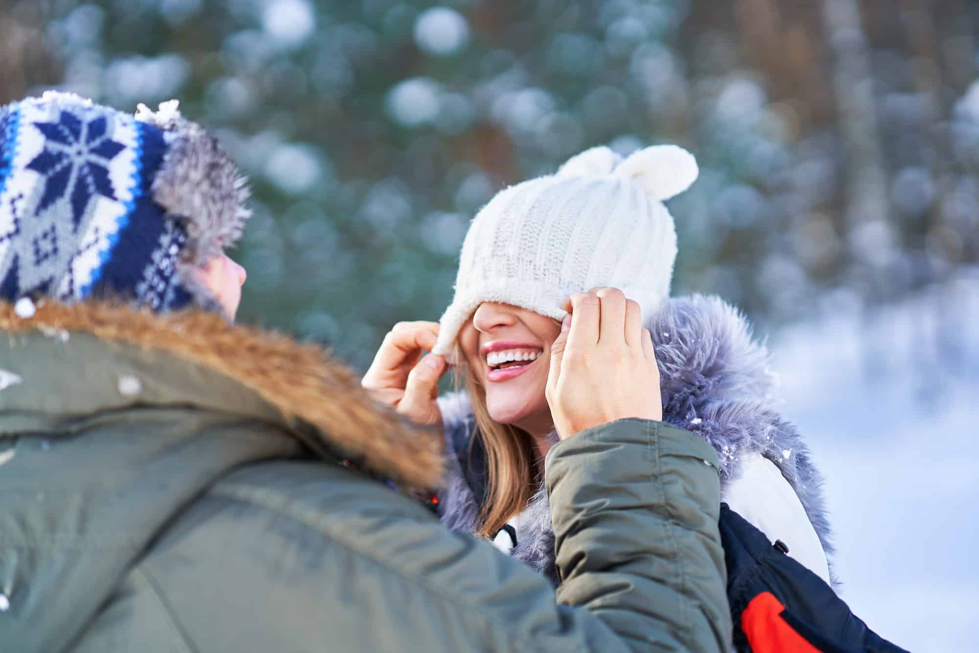 Couple having fun in winter scenery and snow