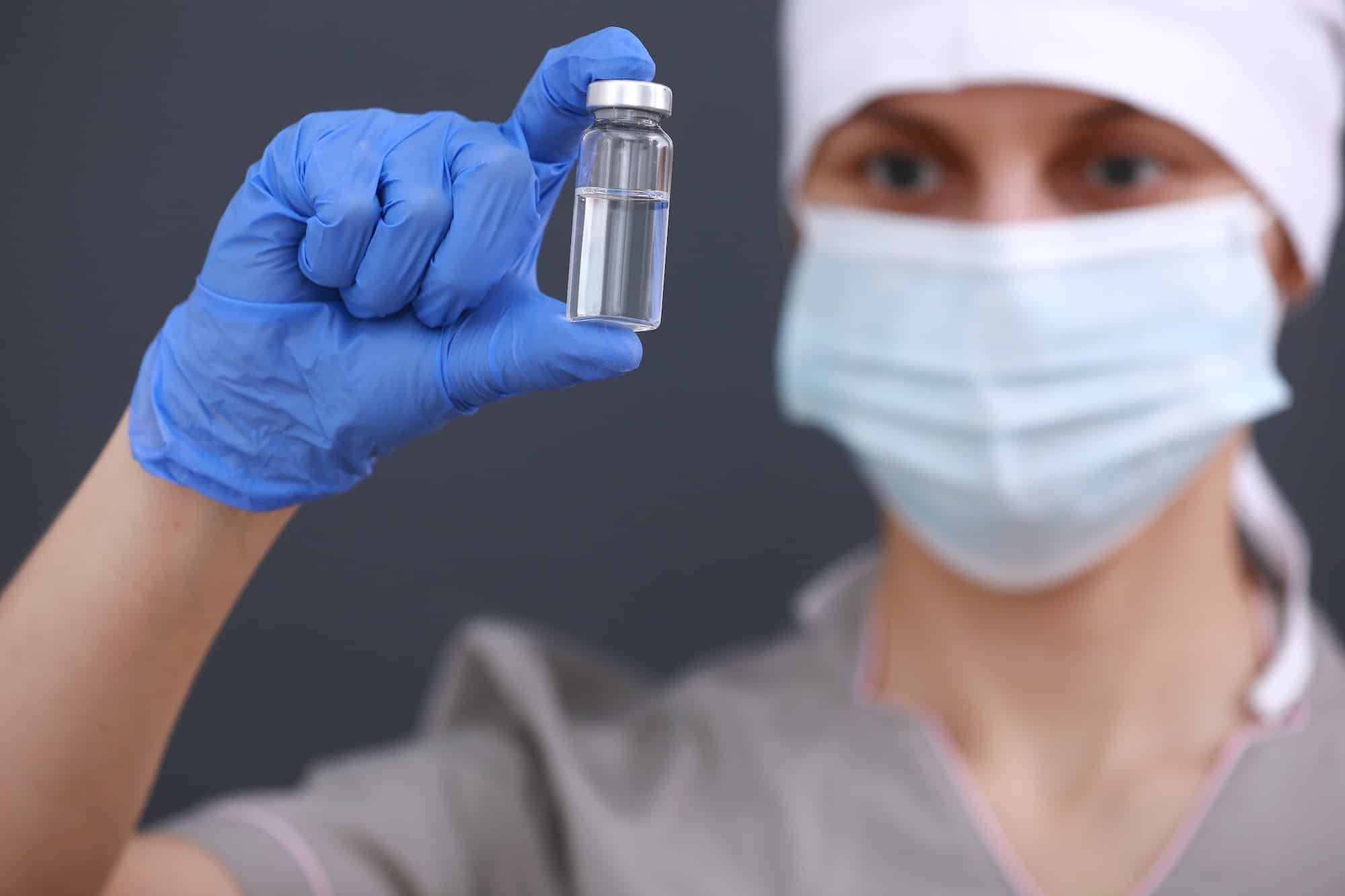 A doctor or scientist in laboratory holding a liquid vaccines for children or older adults, or cure