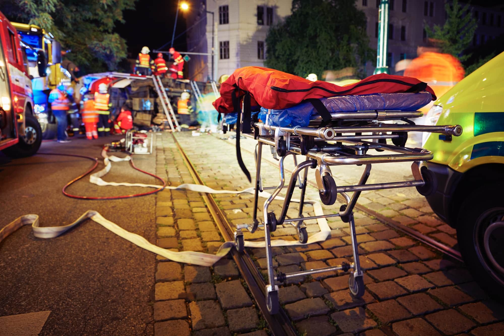 Accident on the city road at night. Themes emergency services and help.