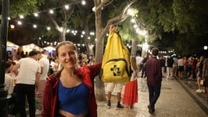 Ukrainian volunteer Olya Matushiv, participating for the third time in World Youth Day (WYD), poses for a photo with a backpack with the symbols of the event, in Lisbon, July 29, 2023.© António Cotrim/Lusa