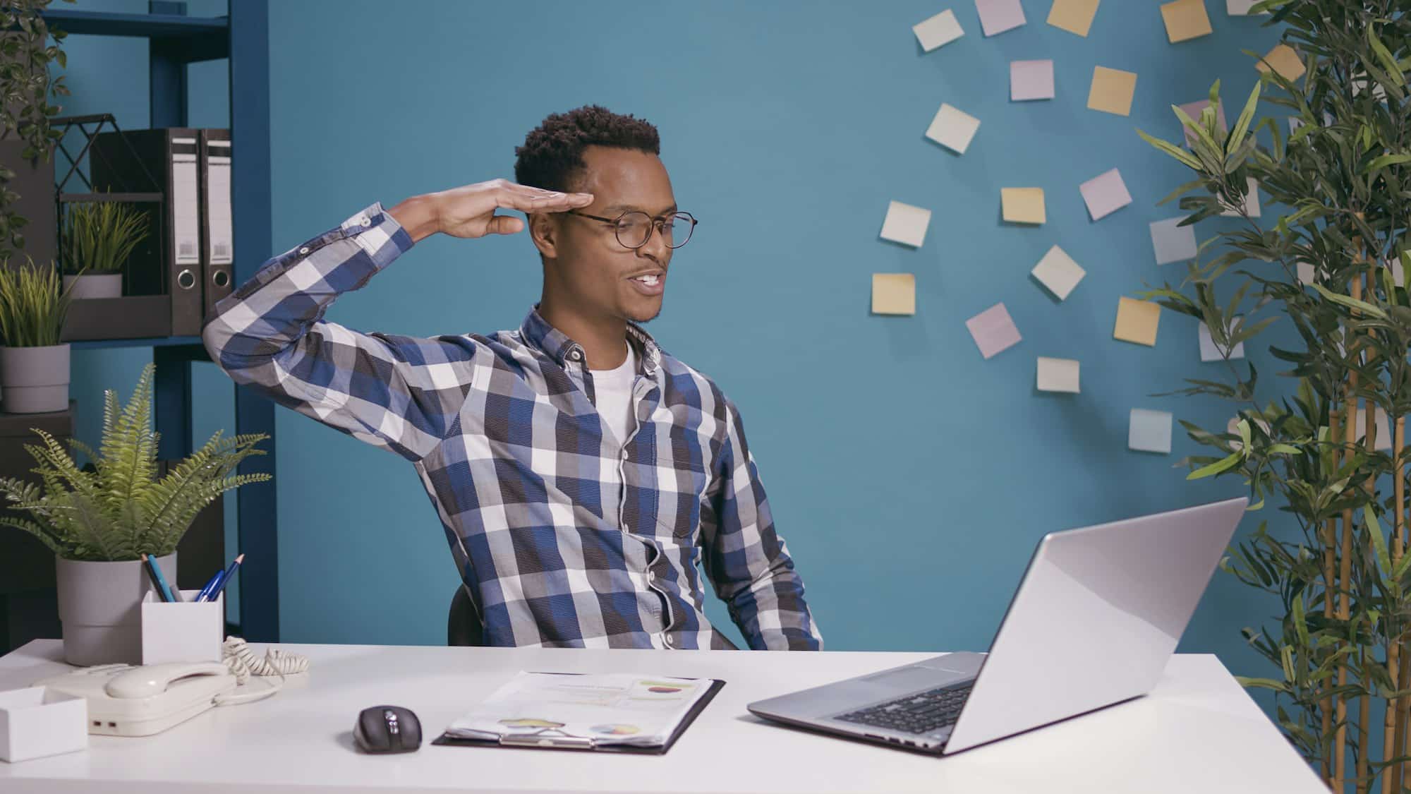 Office worker doing military salute to show respect and patriotism