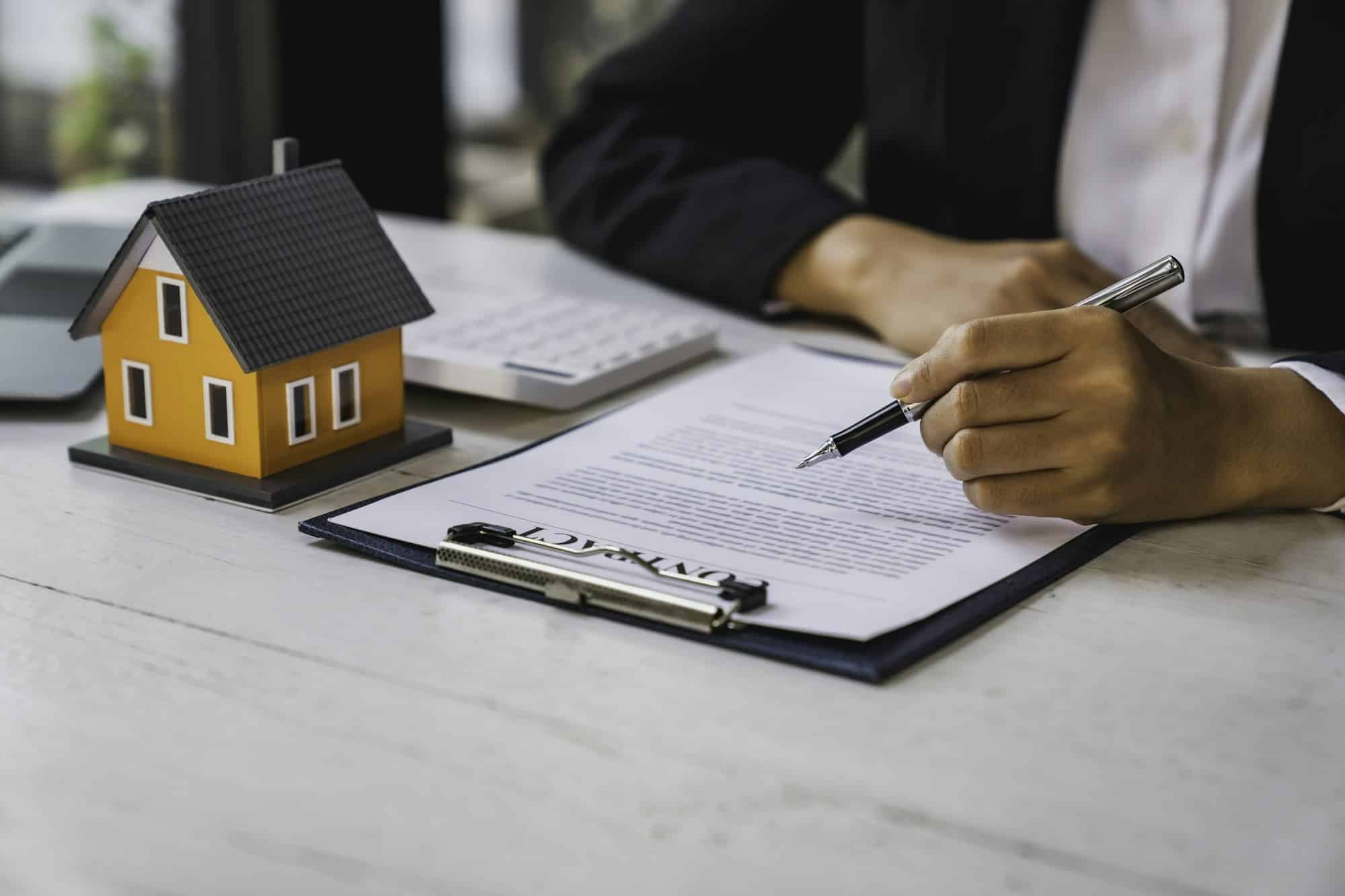 Real estate agent working sign agreement document contract for home loan insurance approving purchas
