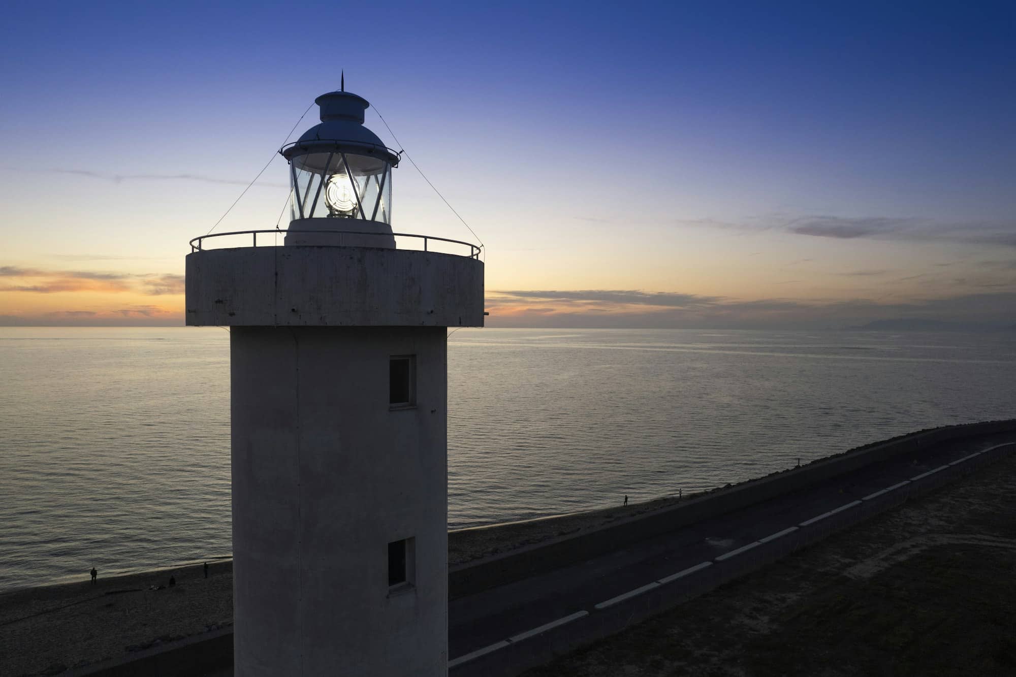 Aerial view of a maritime lighthouse taken at night