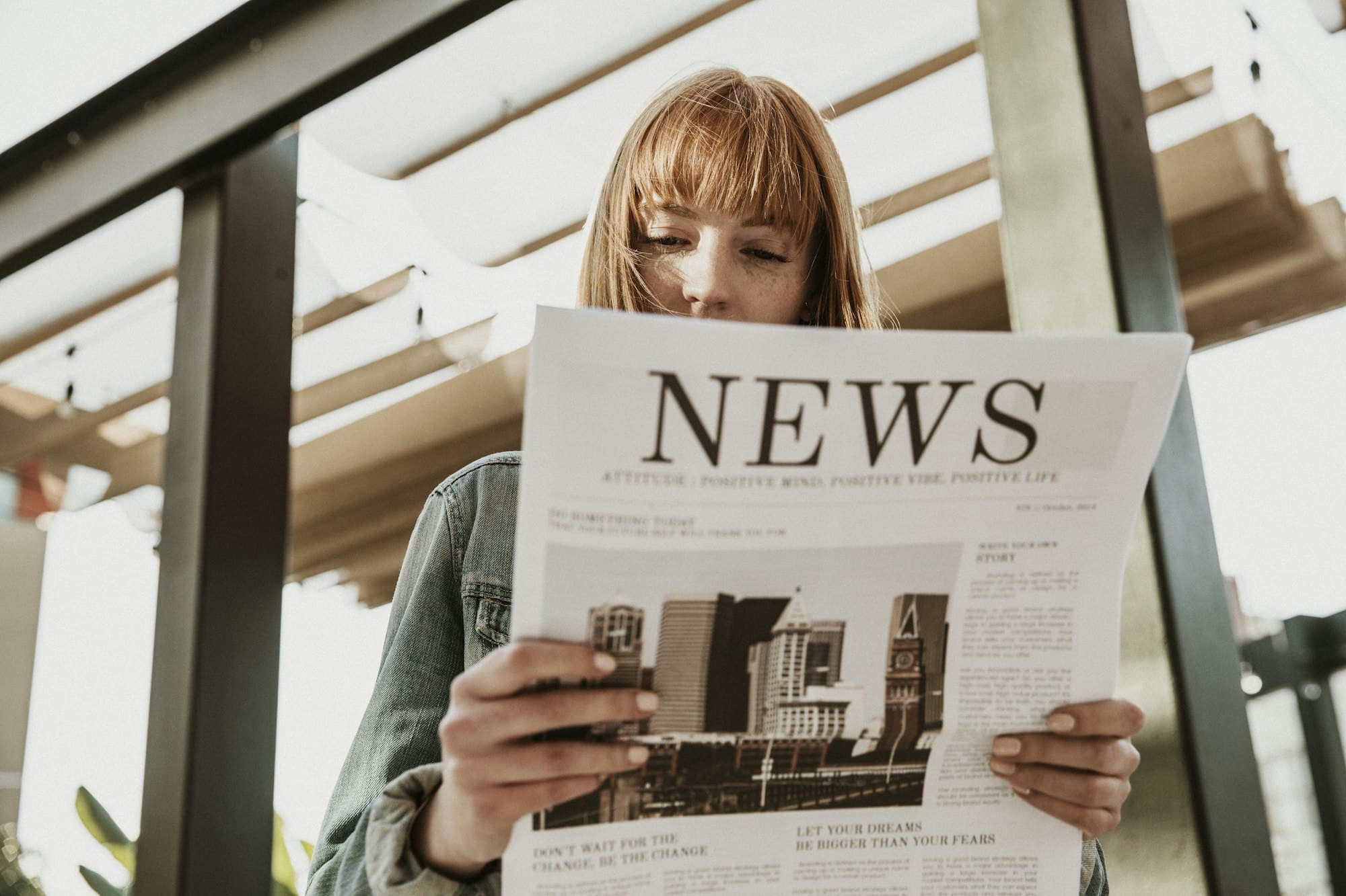 Woman reading paper news