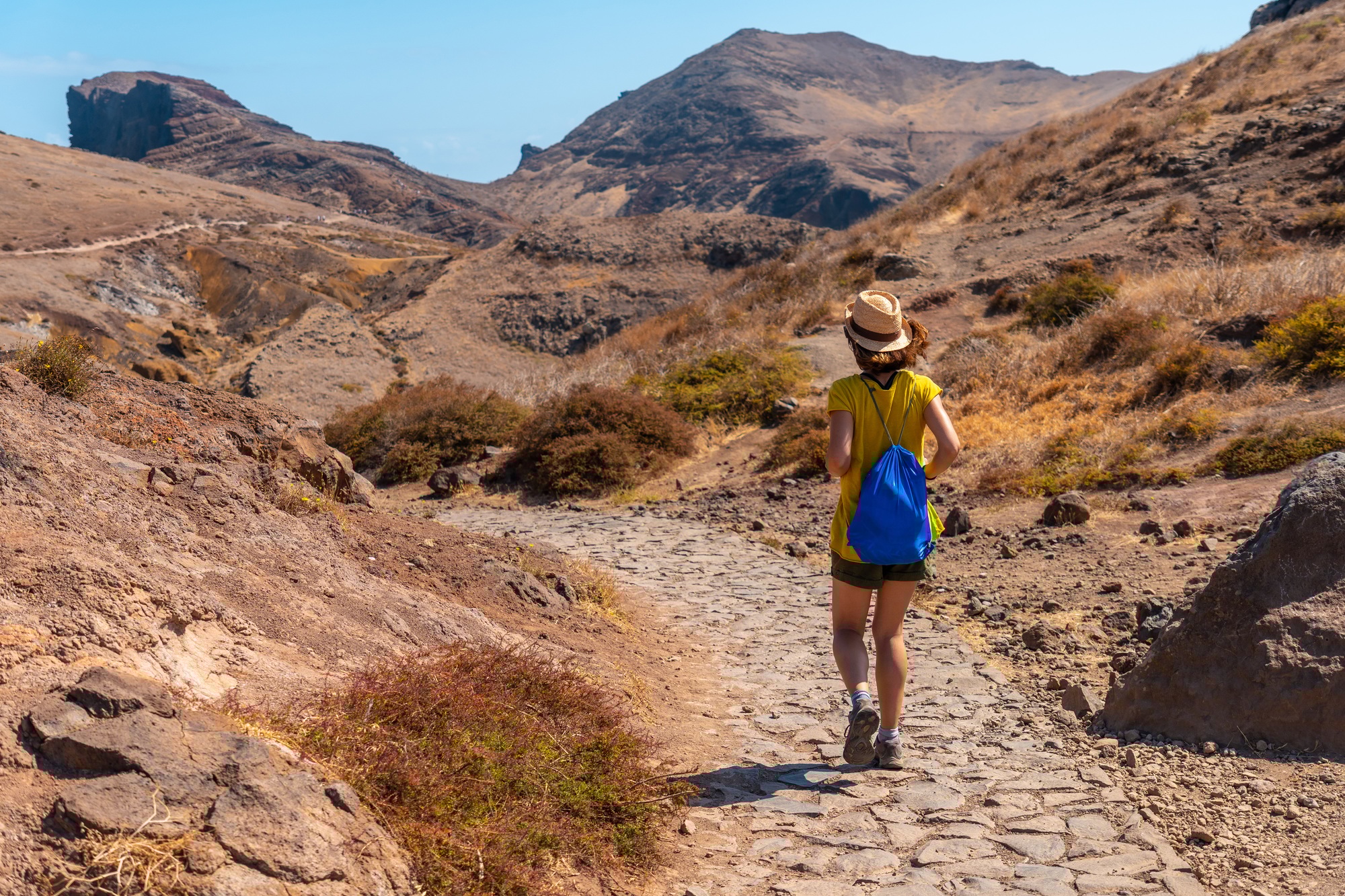 A young woman on a trekking trail in Ponta de Sao Lourenco, Madeira coast