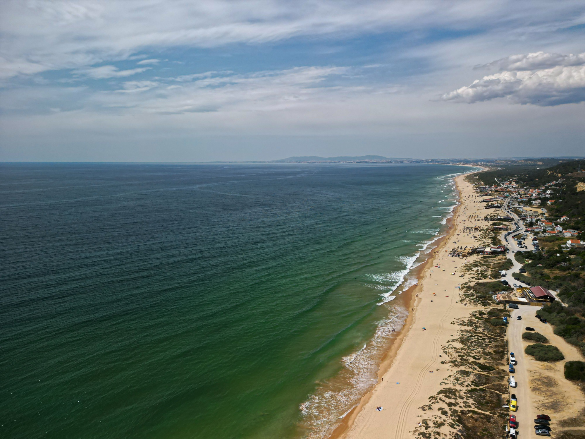 Aerial view of a picturesque view of a tranquil beach in Setubal, Arrabida, Lisbon, Portugal